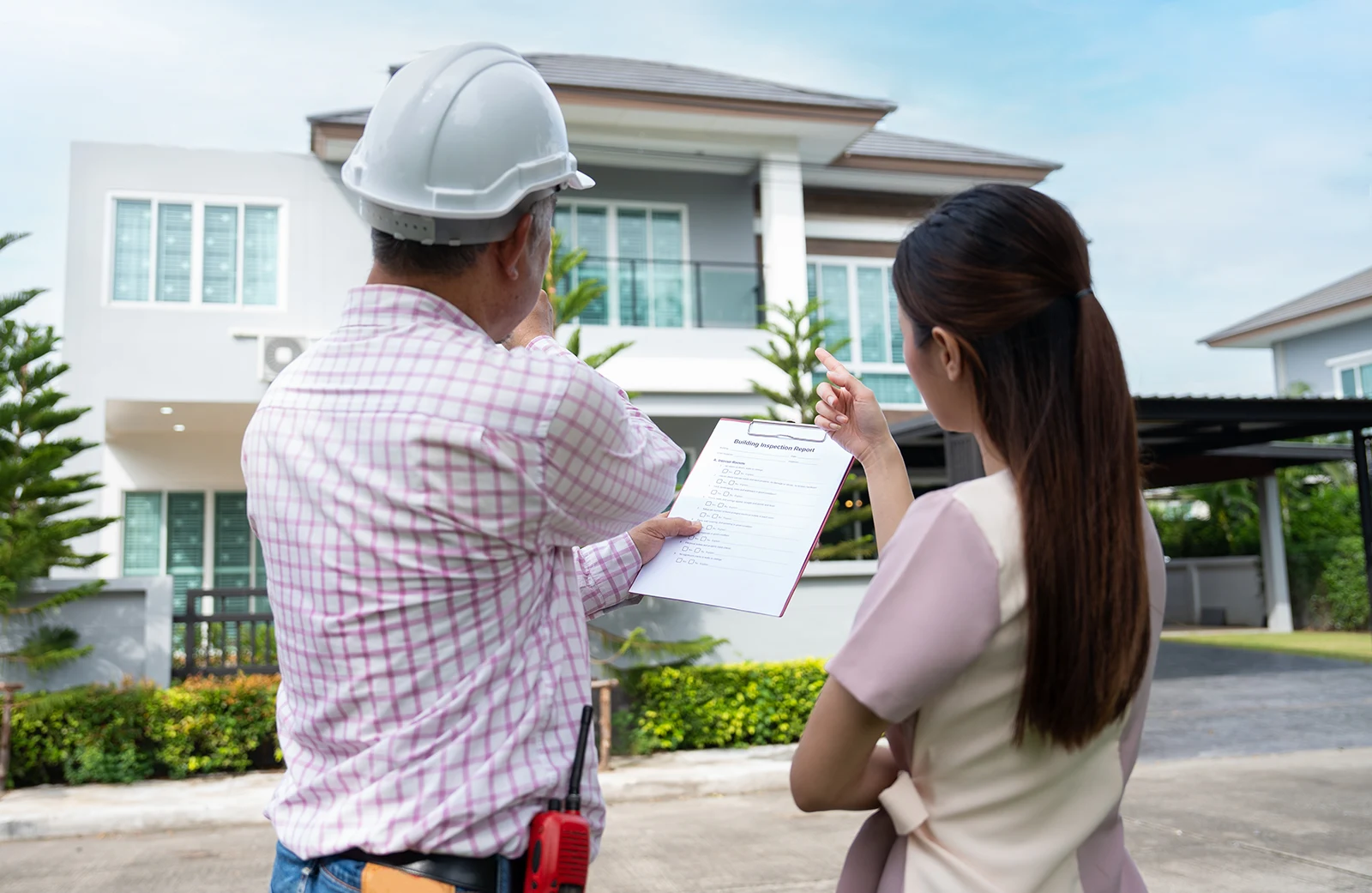 inspector y clienta revisando una vivienda con una lista de verificación
